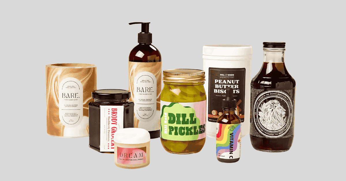 Four brown bottles with different printed and labeled finishes next to sample printing rollers and color guides