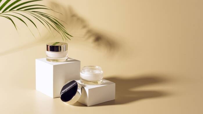 Assorted cosmetic containers including jars and bottles for skincare and beauty products