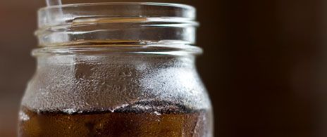 Jar mugs filled with root beer on a restaurant table